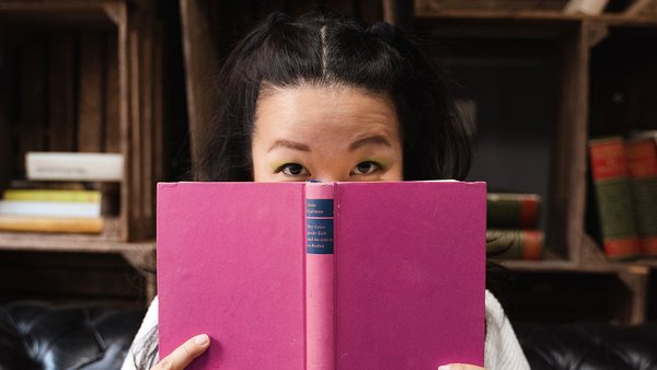 Step 3: Use free time well and find alternatives Young woman holding a book in front of her face