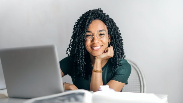 Woman sitting at her desk with a smile Woman sitting at her desk with a smile