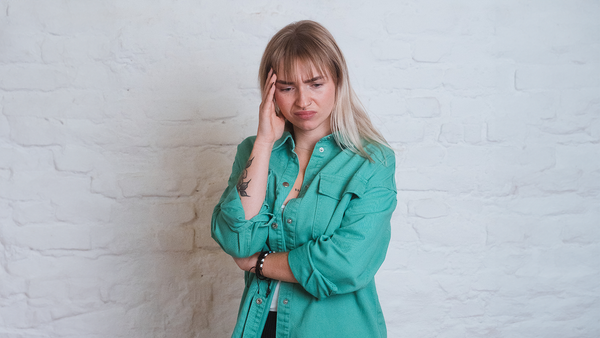 Working sick: Avoiding presenteeism through a resilient corporate culture Woman places her hand on her head
