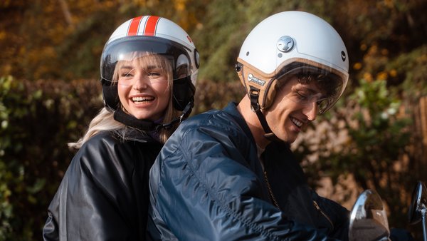 Young Couple is driving on a scooter. Young Couple is driving on a scooter.
